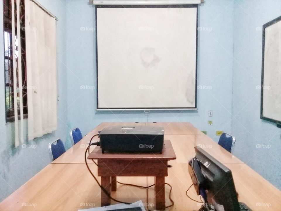 meeting room.consists of a projector,conference table,chers,screens combined with the color of the roomis very suitable