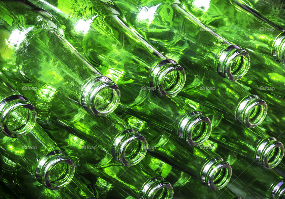 Stack of green color bottles