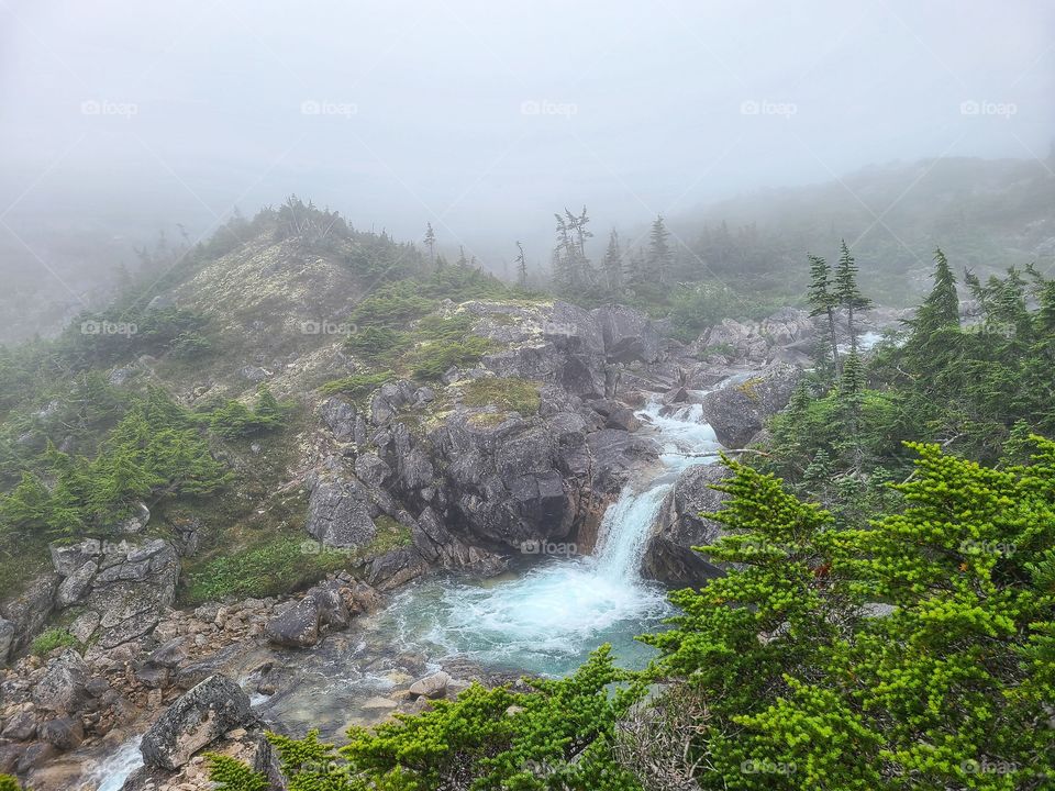 Waterfalls into crystal glacier waters