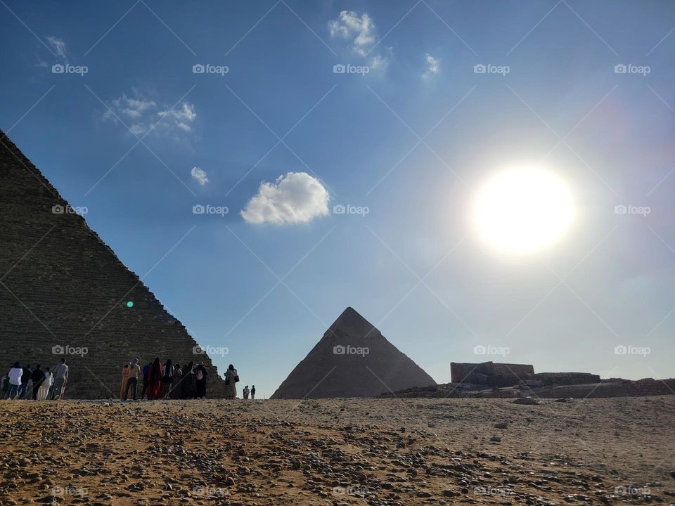 Sunny day with blue sky and a round cloud - father and son pyramids at Giza Cairo Egypt