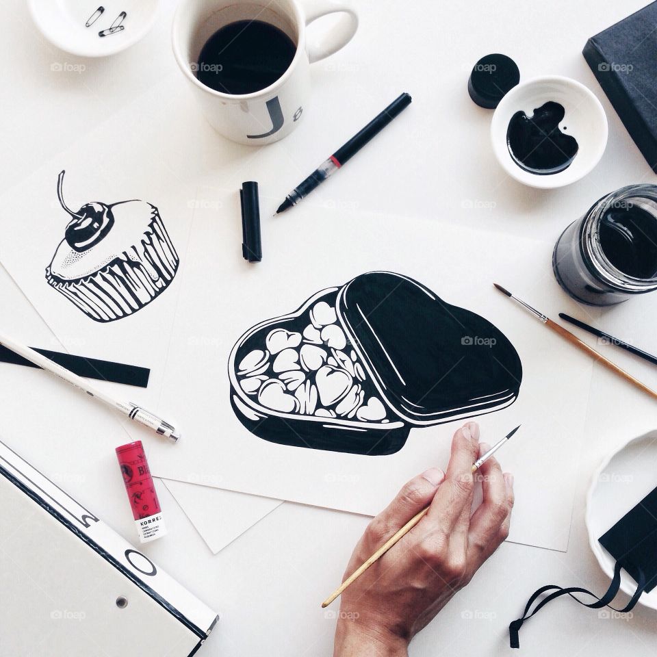Working Desk from Above : Black and white heart shaped candy box painting.