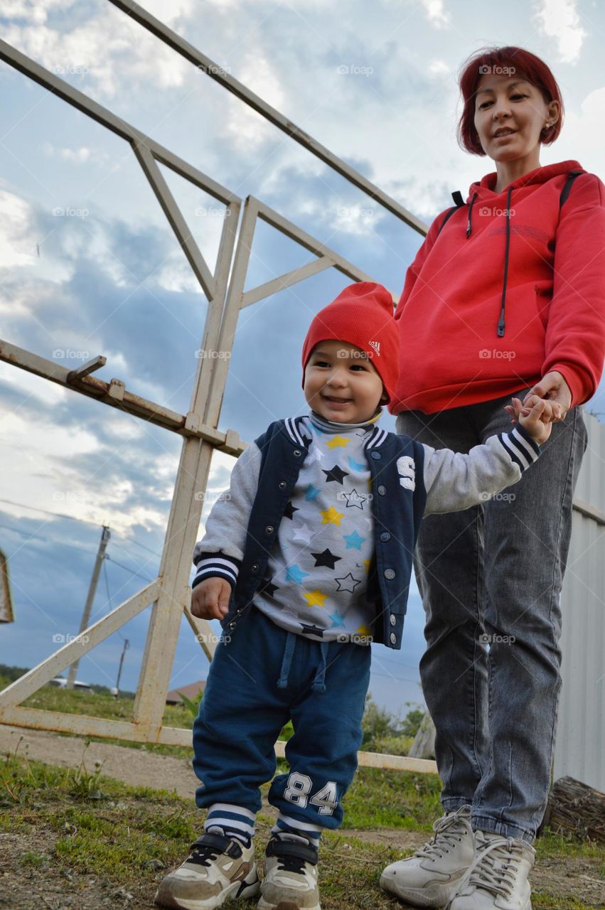 boy under three years old in a red cap smiling