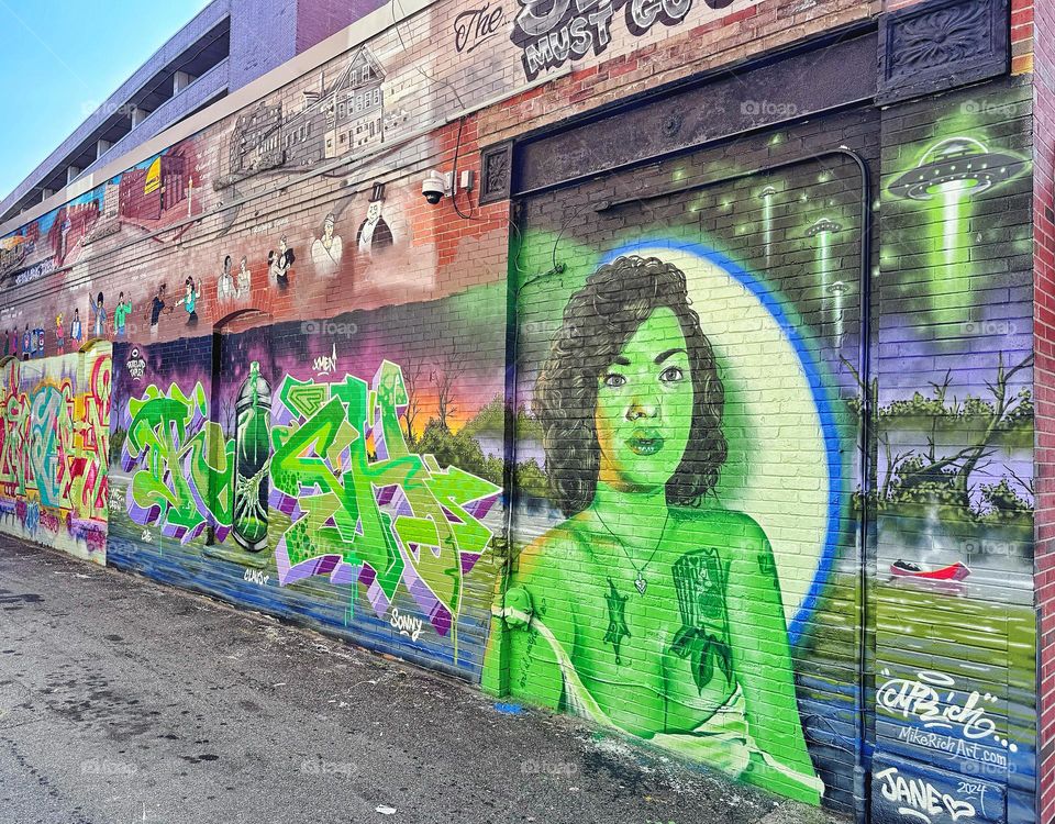 Portrait of a woman on a brick wall 