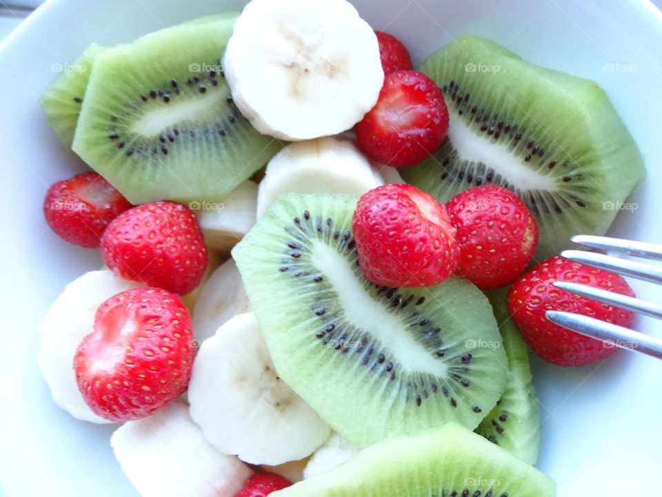 Healthy fruits breakfast full of vitamins with strawberry, kiwi and banana