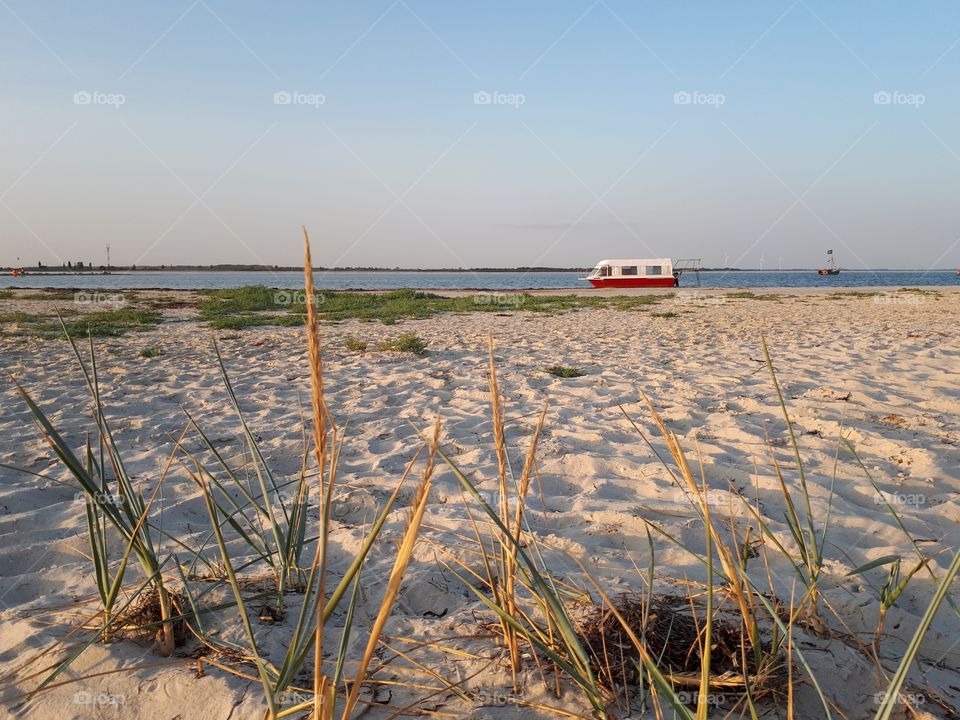 Small old yacht near the beach