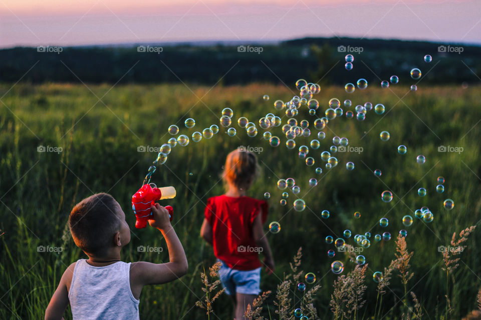 children blow bubbles