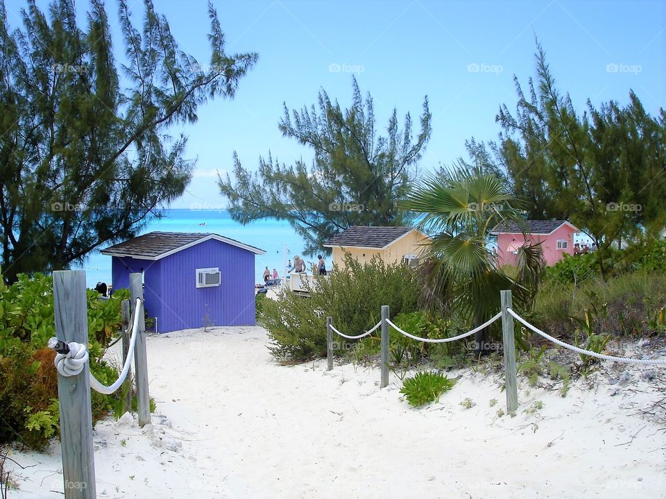 Golden sands, turquoise waters & colourful huts in the Bahamas 