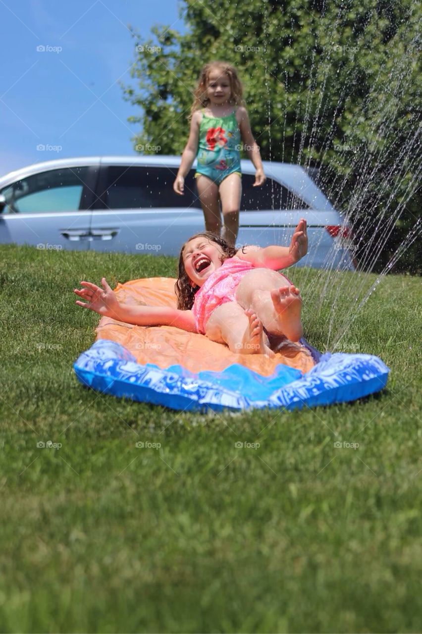 Smiling girl lying on inflatable mattress