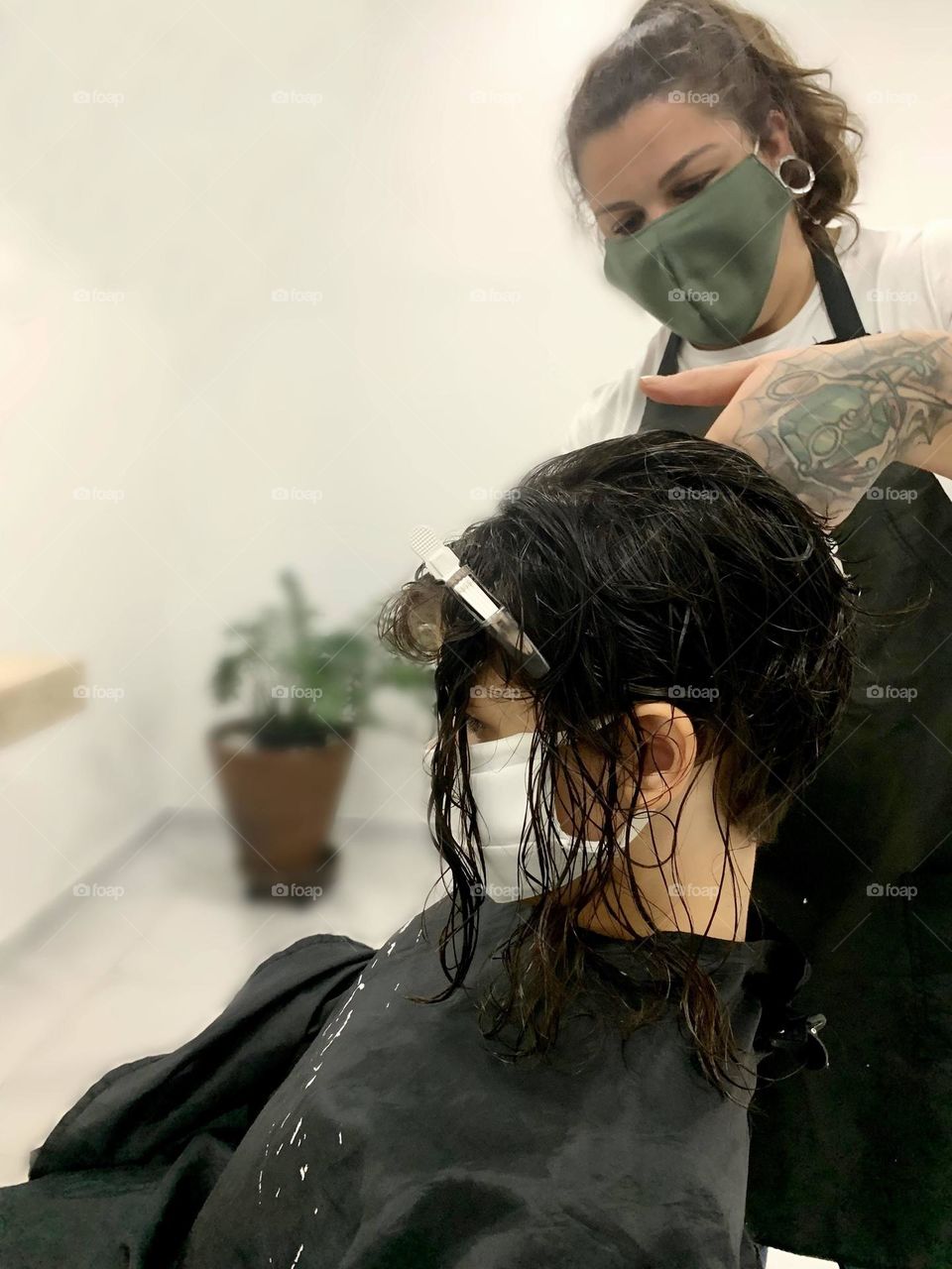 hairdresser cutting girl's hair