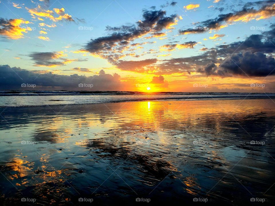 A beautiful reflection shot of the ocean at sunrise