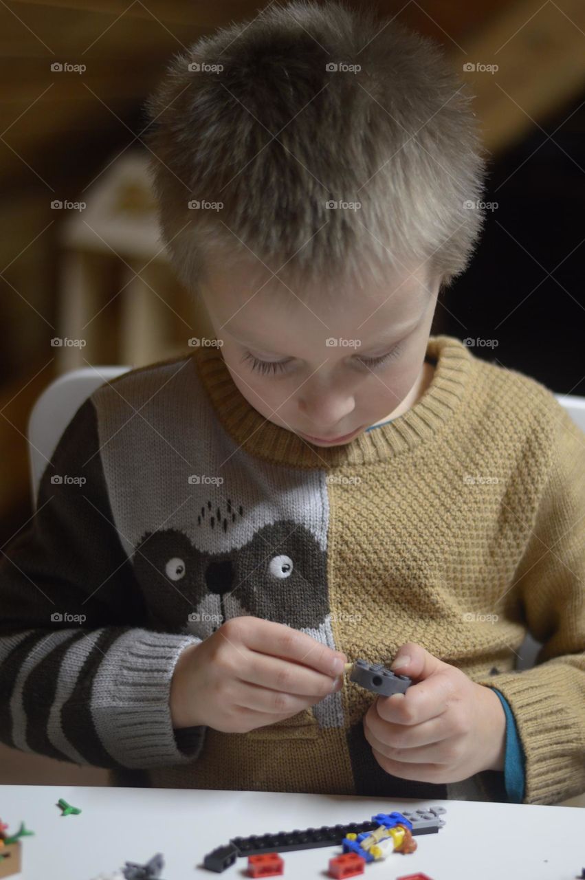 boy playing with lego