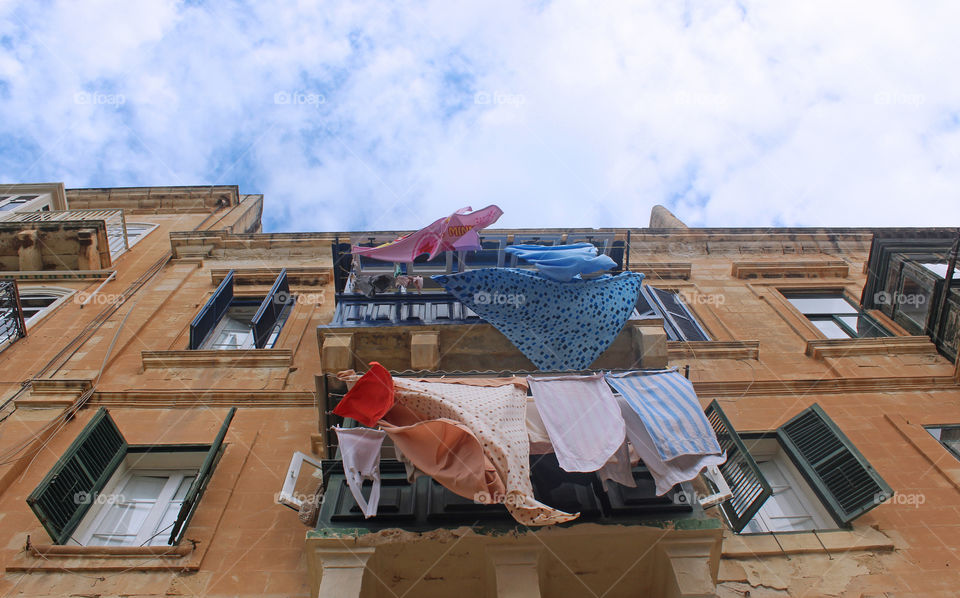 colorful clothes on the line outside a mediterranean balcony