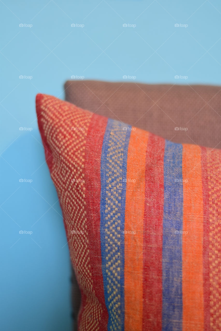 Orange color story. Orange red and blue striped pillow