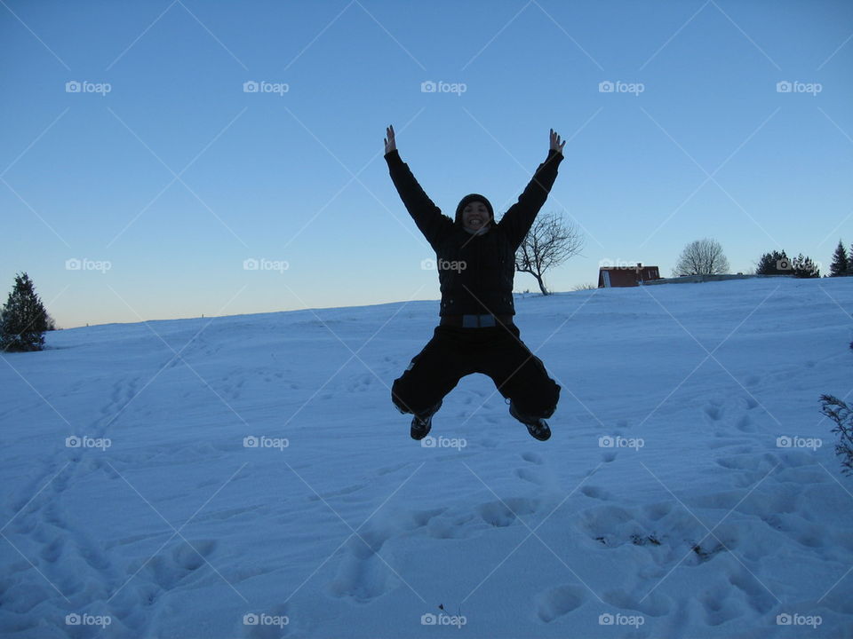 girl jumping in the snow