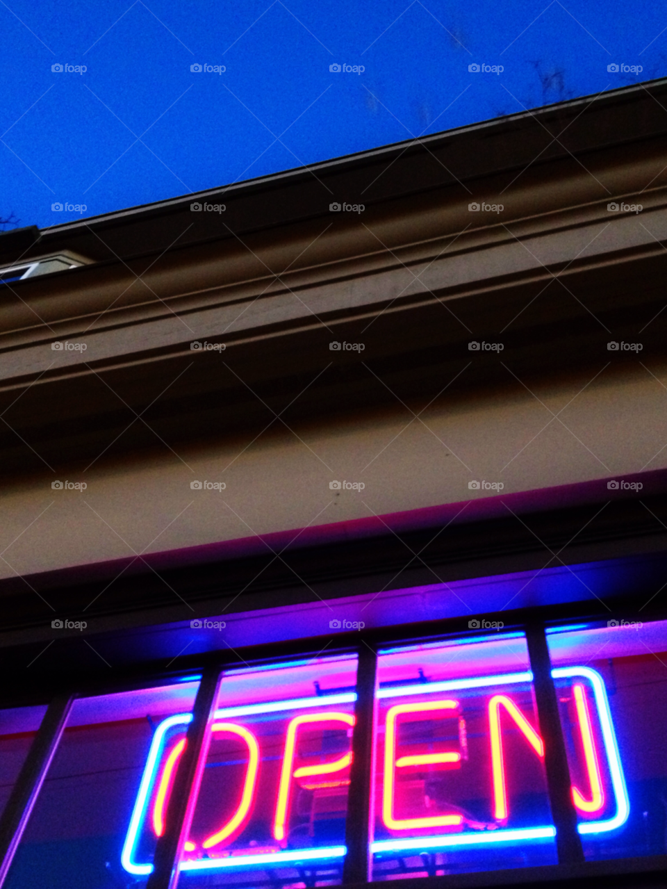 neon blue sky open sign too of building by sellershot