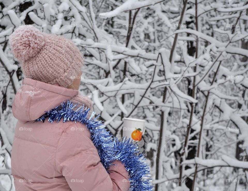 sweater weather woman with cup in snowy park winter time