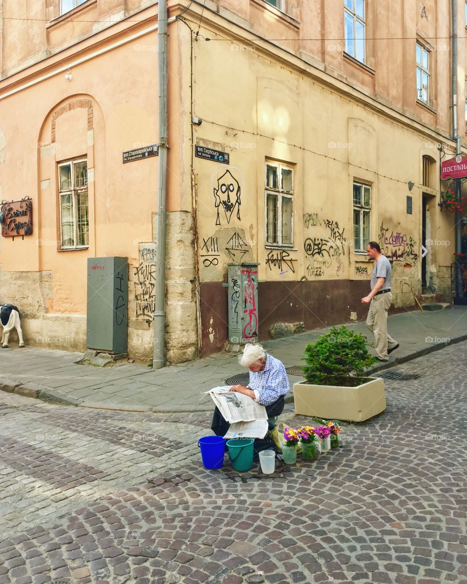 Old woman selling  bouquets at the street 