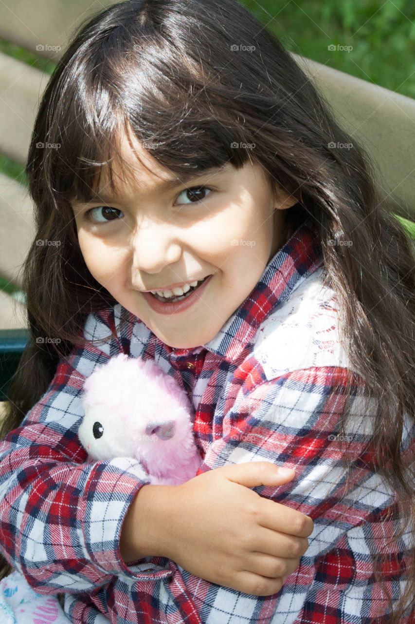 Portrait of a girl hugging plush toy