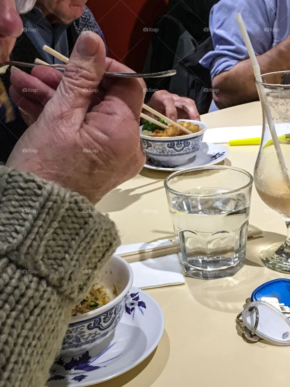 Senior hands shown,  eating at restaurant table