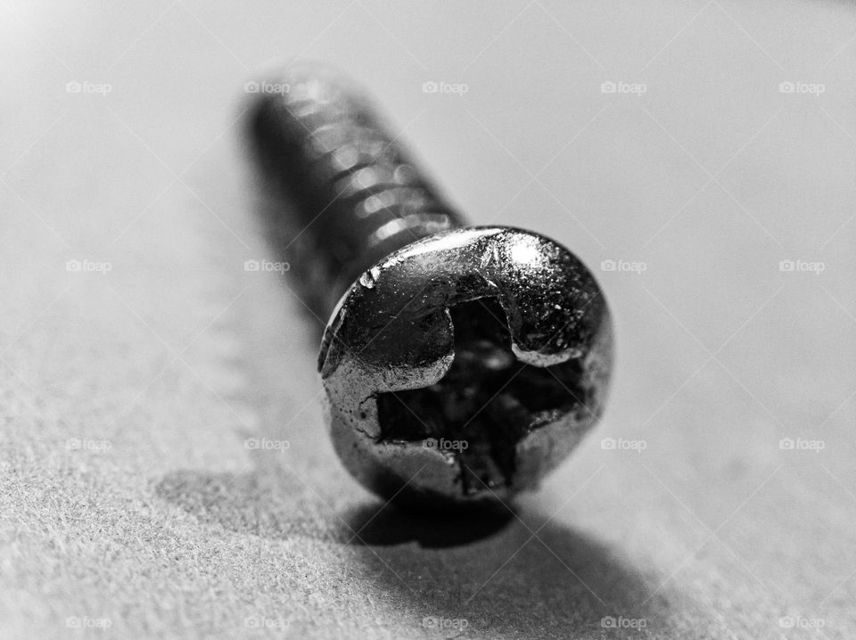 Screw on a light background in black and white.