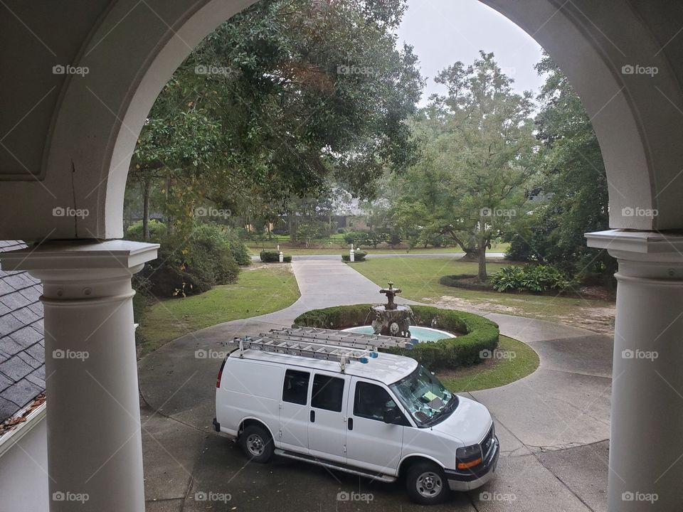 Contractor van workers home repairs through the window in the driveway 