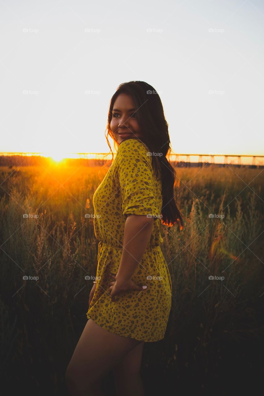 Posing in the rural sunset. Beautiful young girl. 