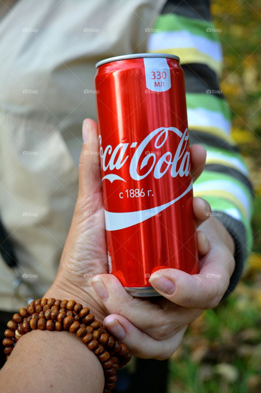 coca cola in hands people, drinking coca cola outdoor