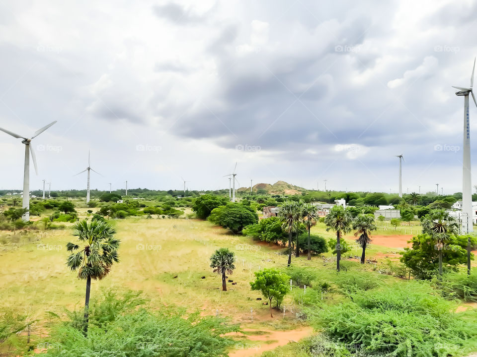 wind mill on an outer area of a village