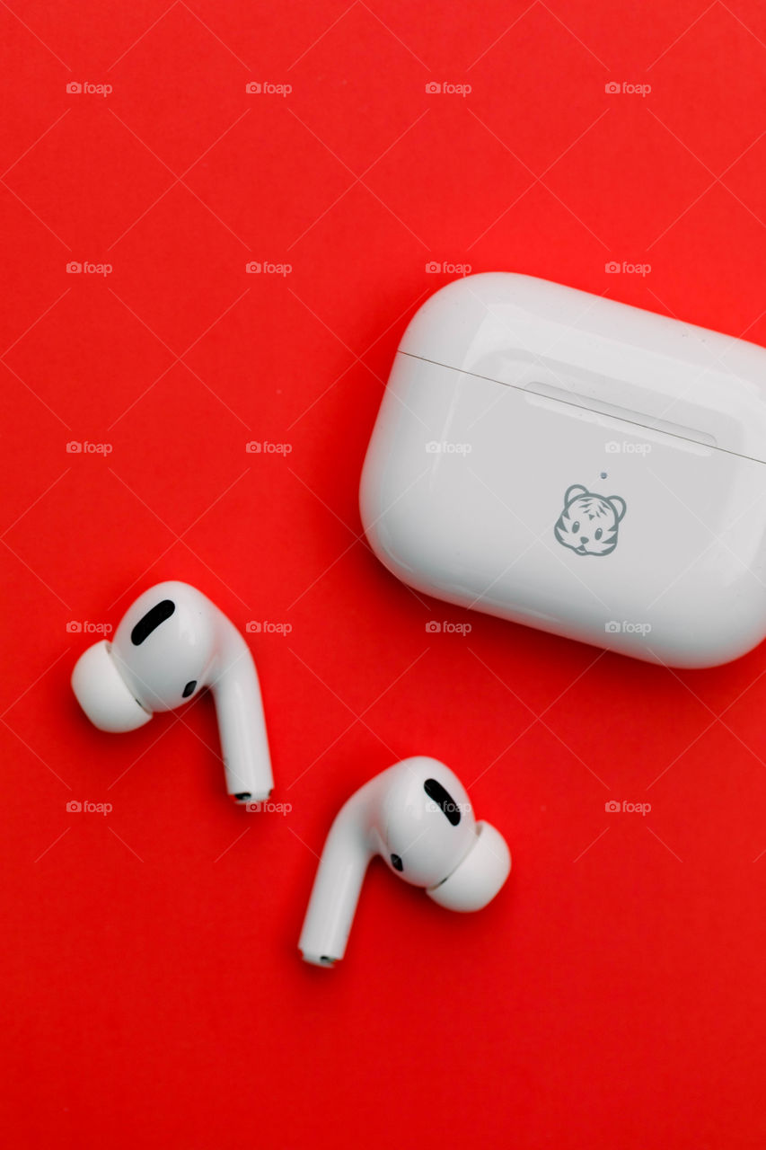 AirPods on red background