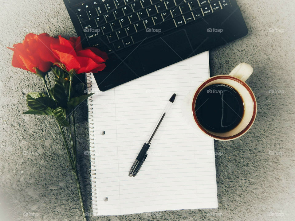 Office Essentials, Laptop, notebook, coffee and roses. Desktop view.