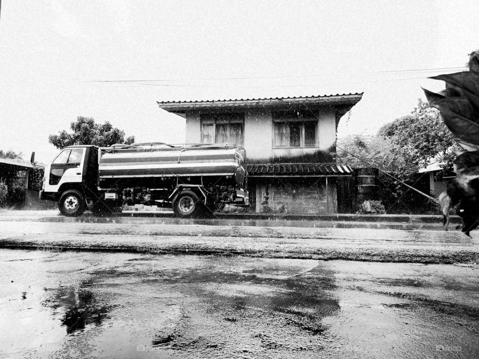 Truck and​ house in​ the rain