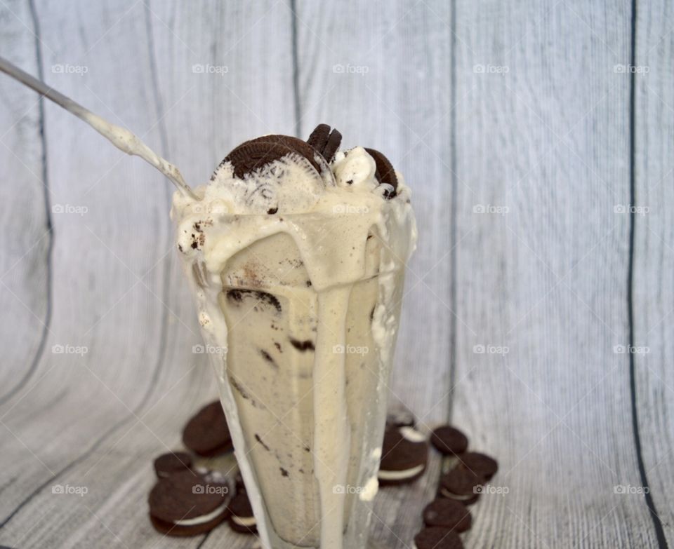 Oreo cookie milkshake with a wooden rustic white background