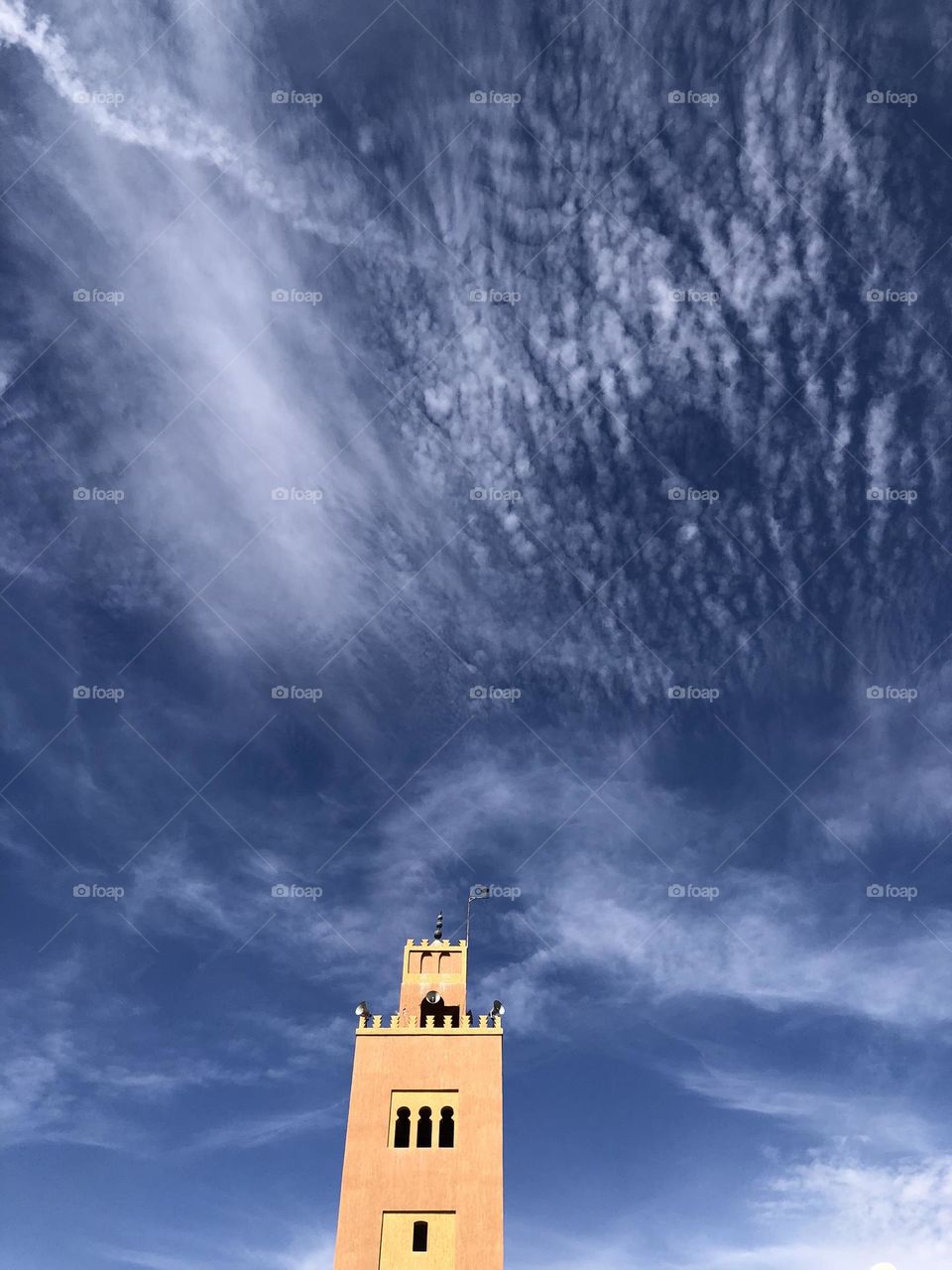 Beautiful minaret of a mosque embracing the sky .