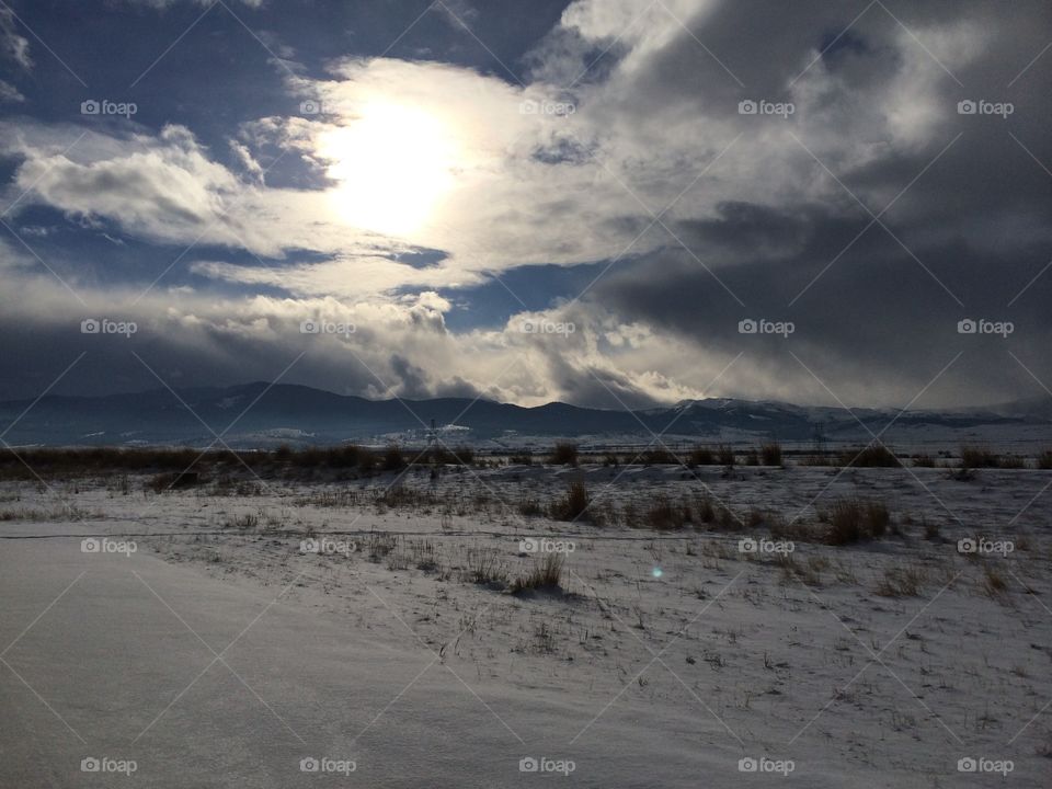 Wintery plain with mountains in distance