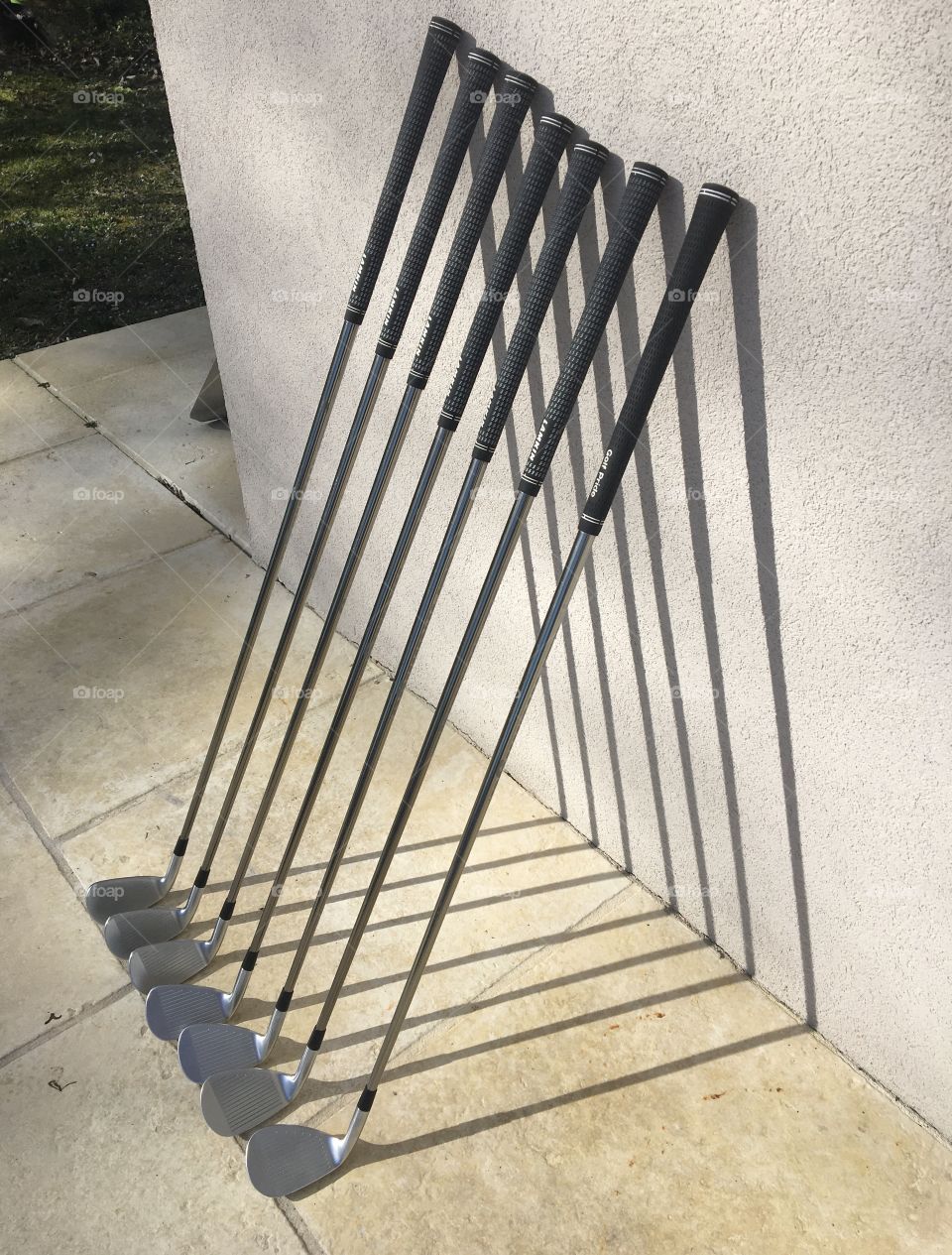 Golf clubs along a wall 