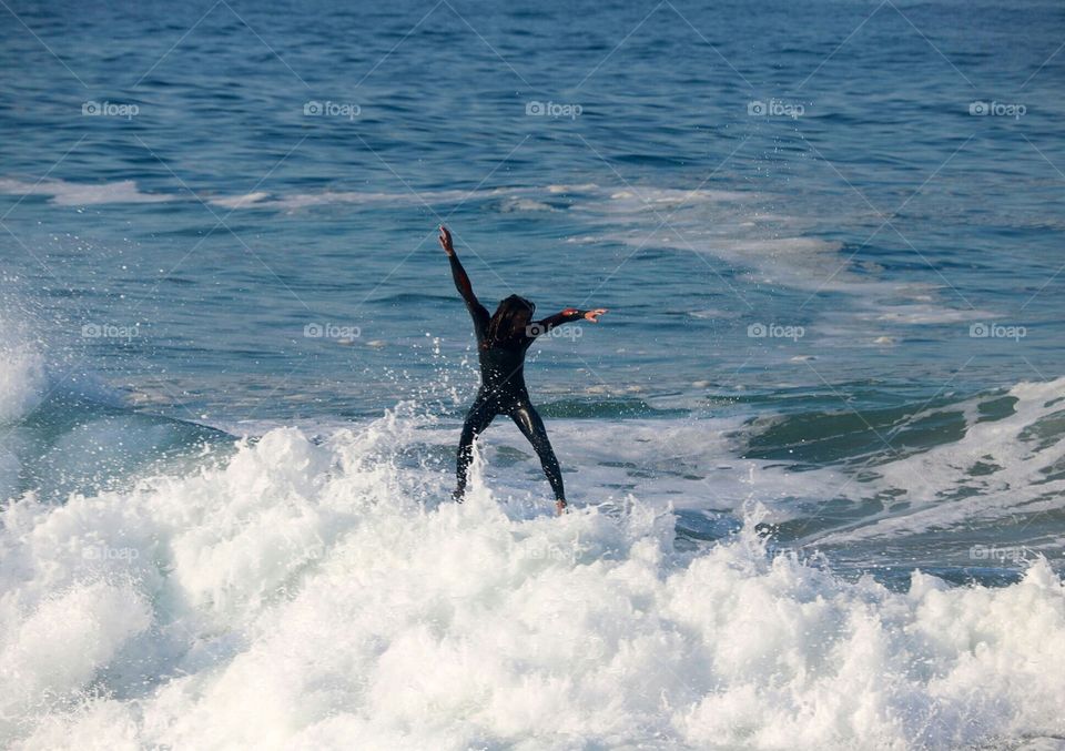 Surfer on top of a huge wave at The Wedge, Newport Beach, CA