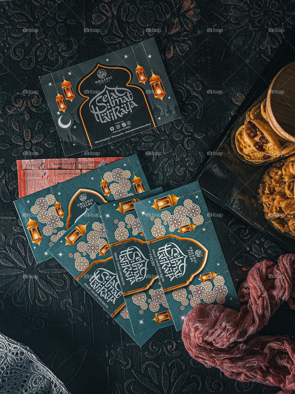 Sampul raya or money gift in an envelope decorated with Raya celebration. On top view