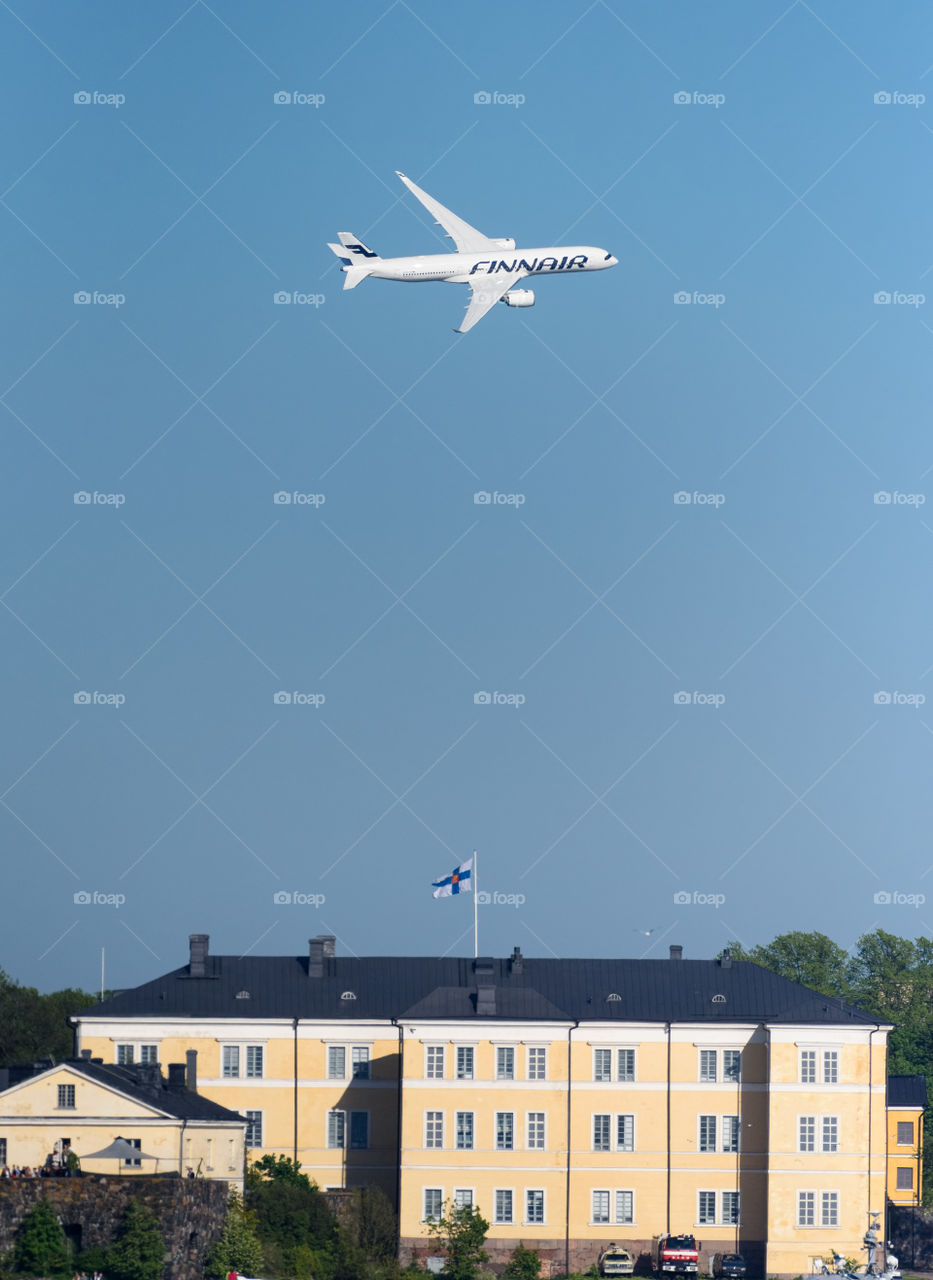 Helsinki, Finland - 9 June 2017: Finnair Airbus A350 XWB airliner flying in extremely low altitude over Suomenlinna fortress island at the Kaivopuisto Air Show.