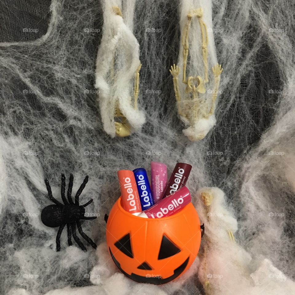 Skeletons with spider web, toy spider and a bucket of Labello lip balm 