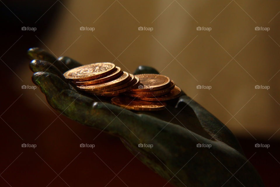 Statue figure holding arrhae gold coins