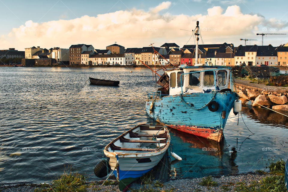 Colorful old boats in the Corrib River at Galway City in Ireland