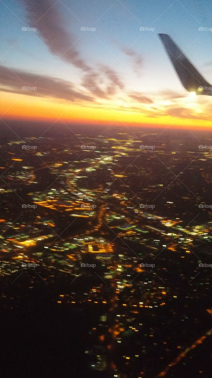 Blurry aerial view of a sunrise over San Antonio, TX.