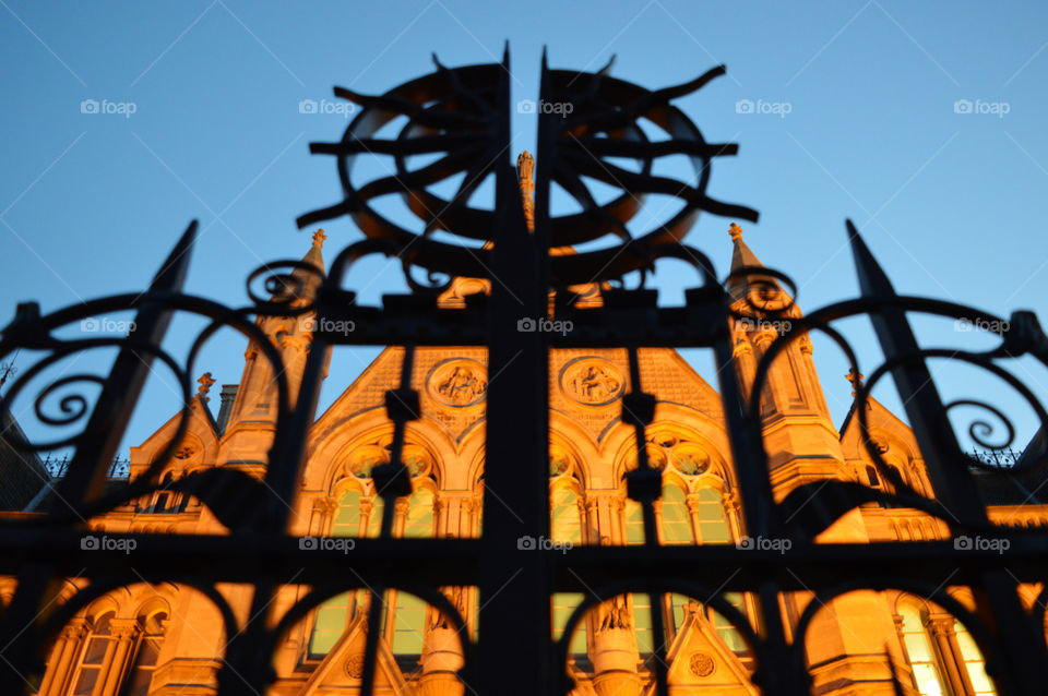 looking up. gate of the university in England during dusk