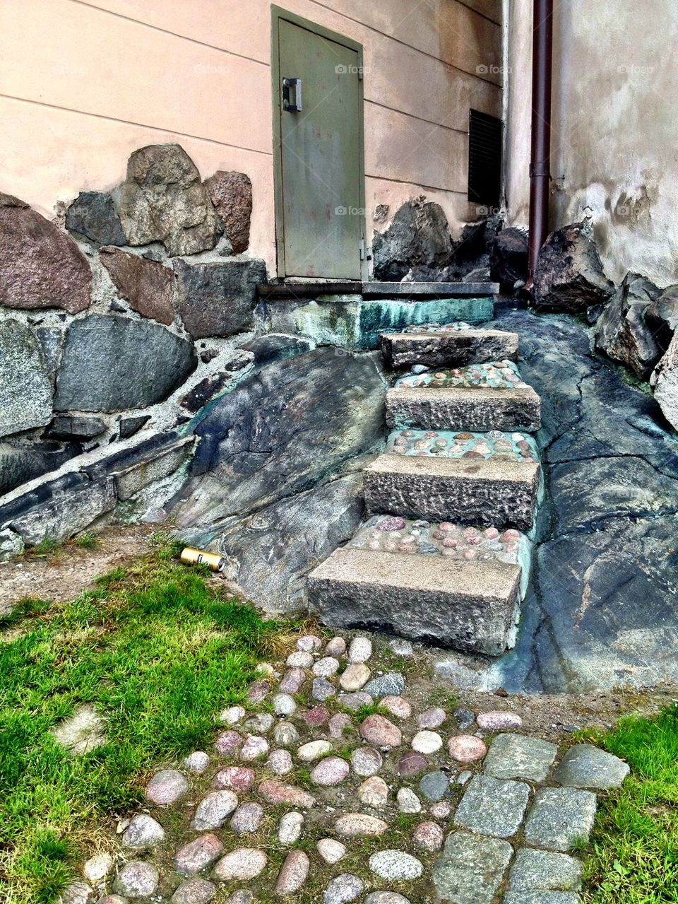 Stone stairway and pebbles to door