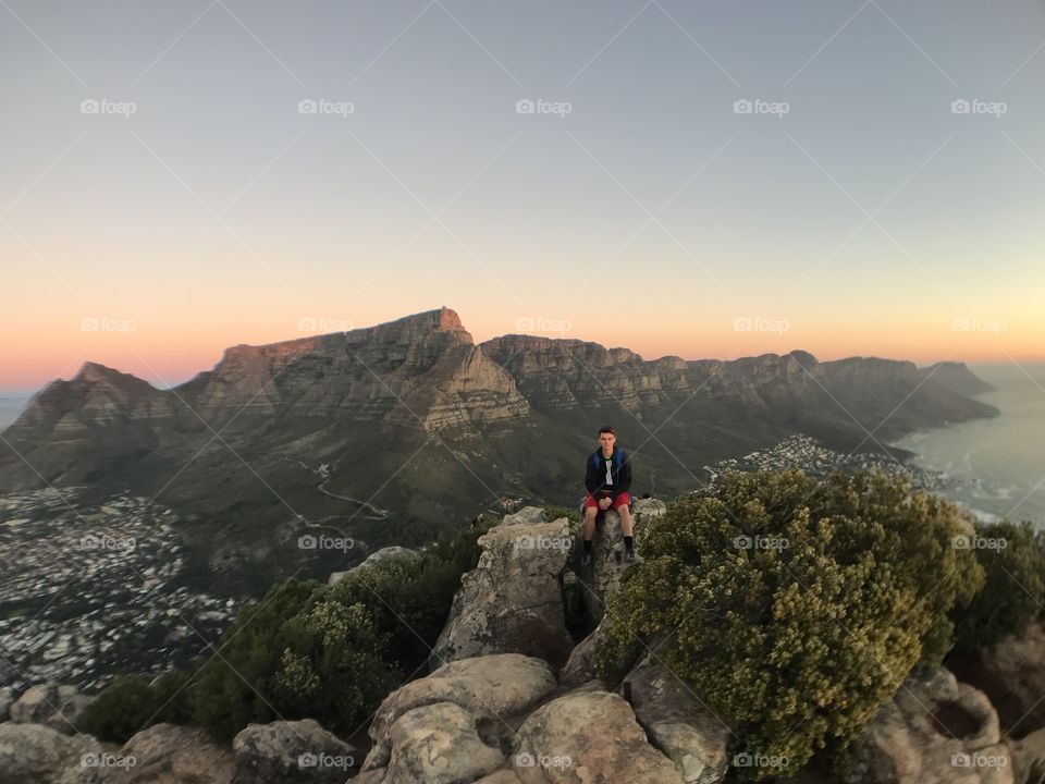 Cape Town, South Africa. Sitting atop Lion’s Head with Table Mountain in the background.