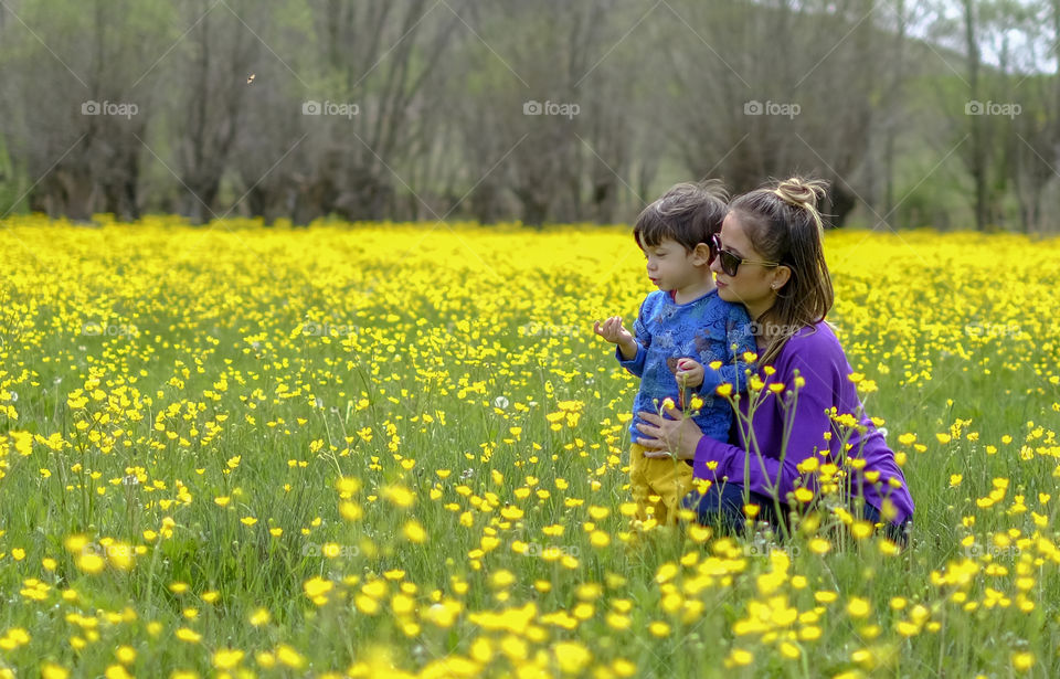 Mother and son in flower field