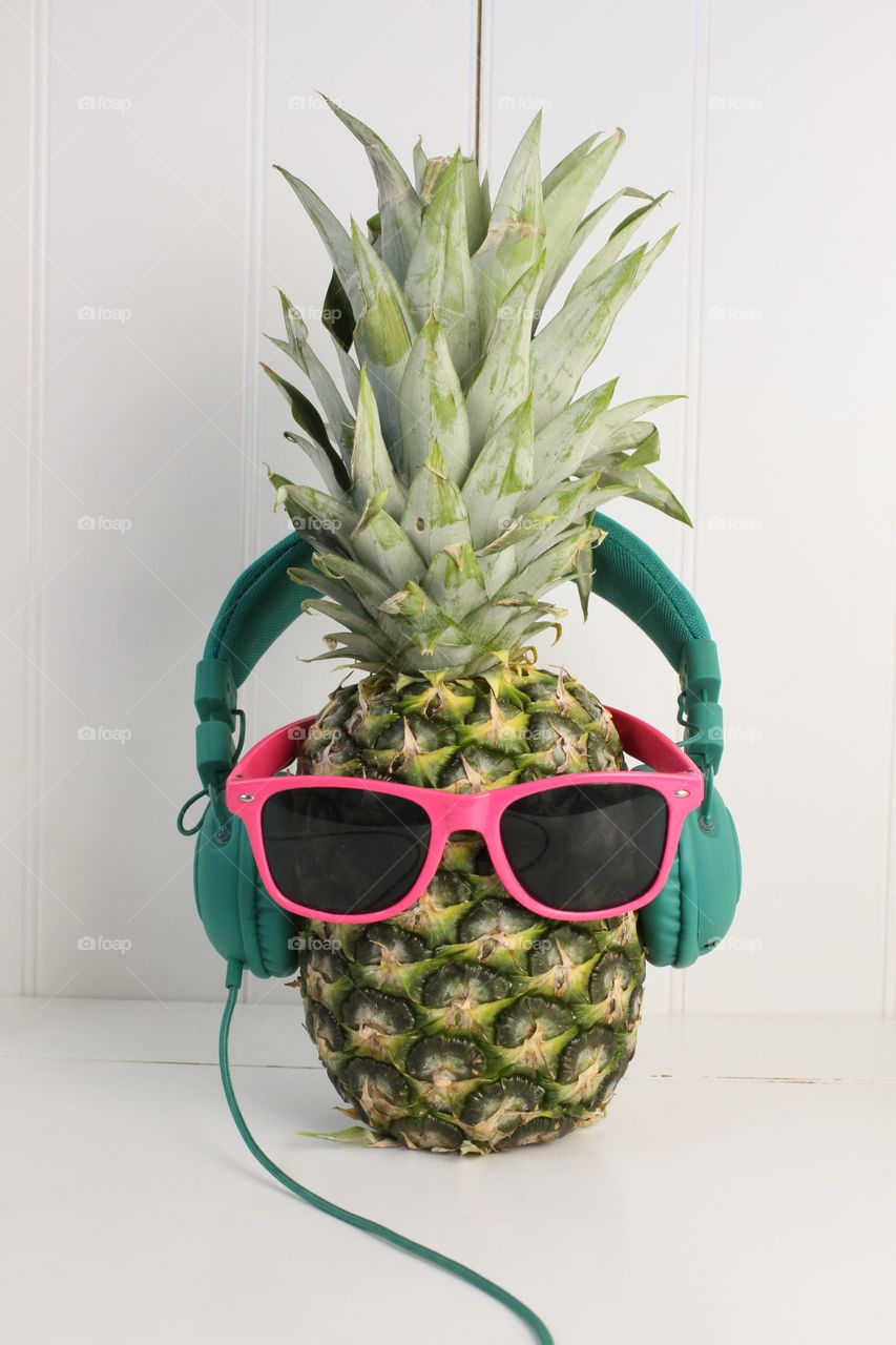 Pineapple wearing headphones and glasses