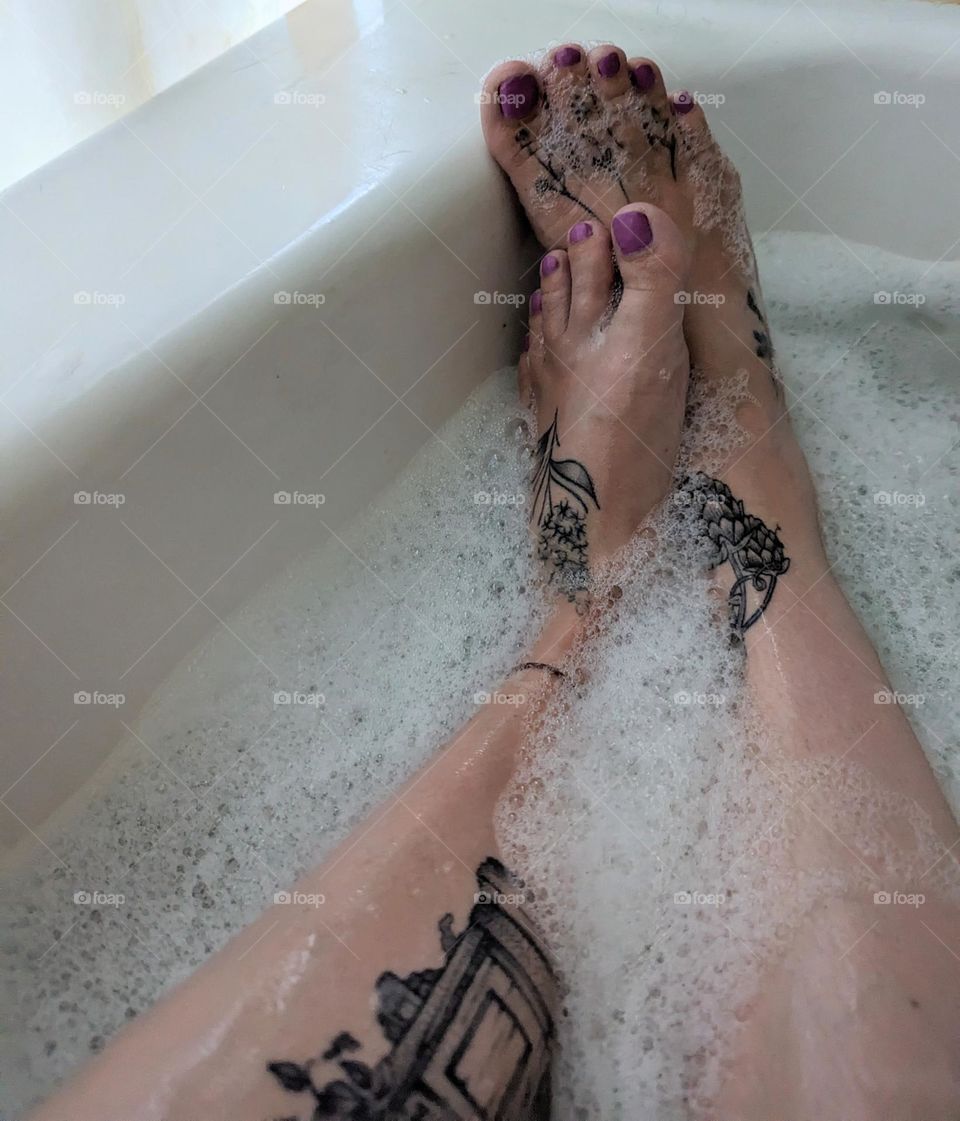 cute feet soaking in the tub with bubble bath and relaxing zen music foot bath bubbly feet tattooed feet