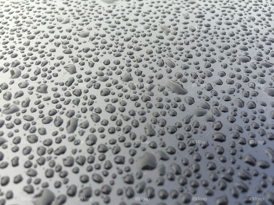 Water droplets. Water droplets on a black silver surface