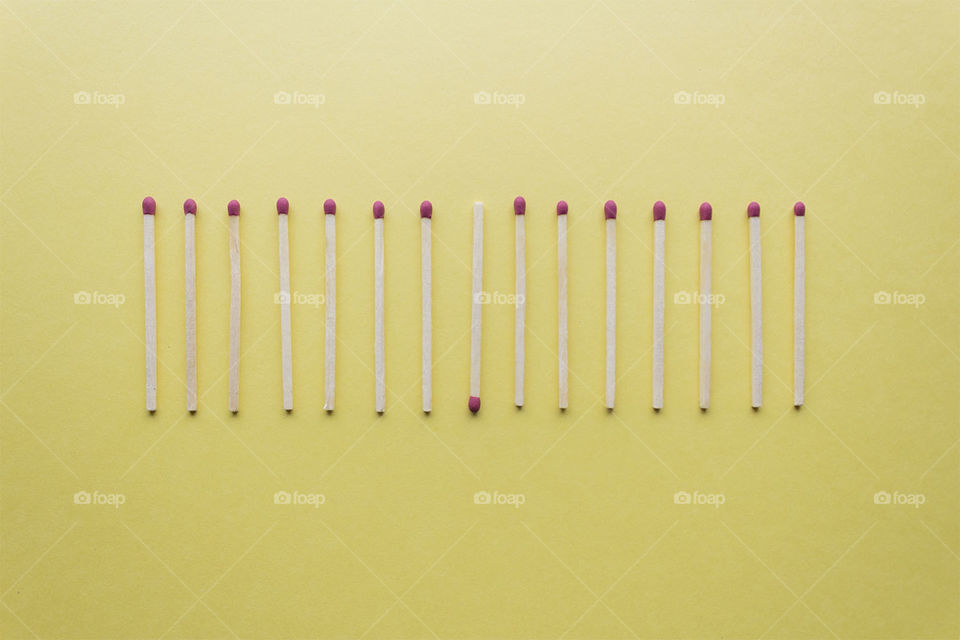 Minimalist line of matches on a pastel background 